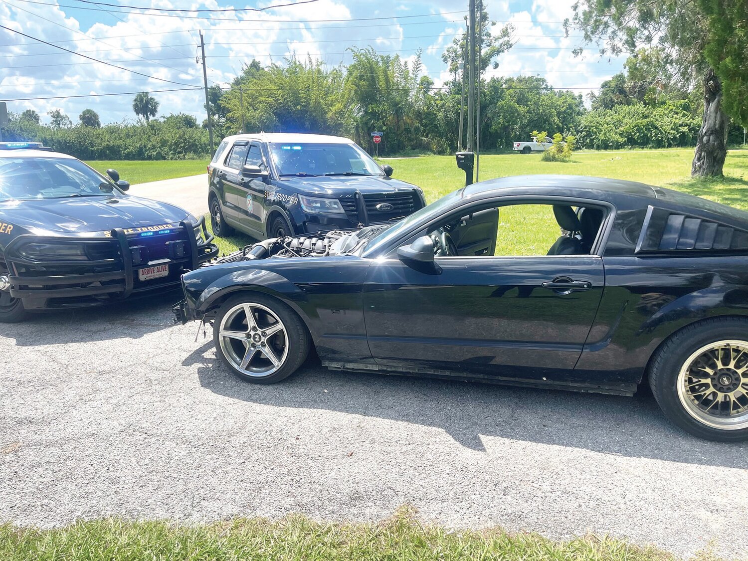 Side view of the black Ford Mustang. The silver strips were painted over.